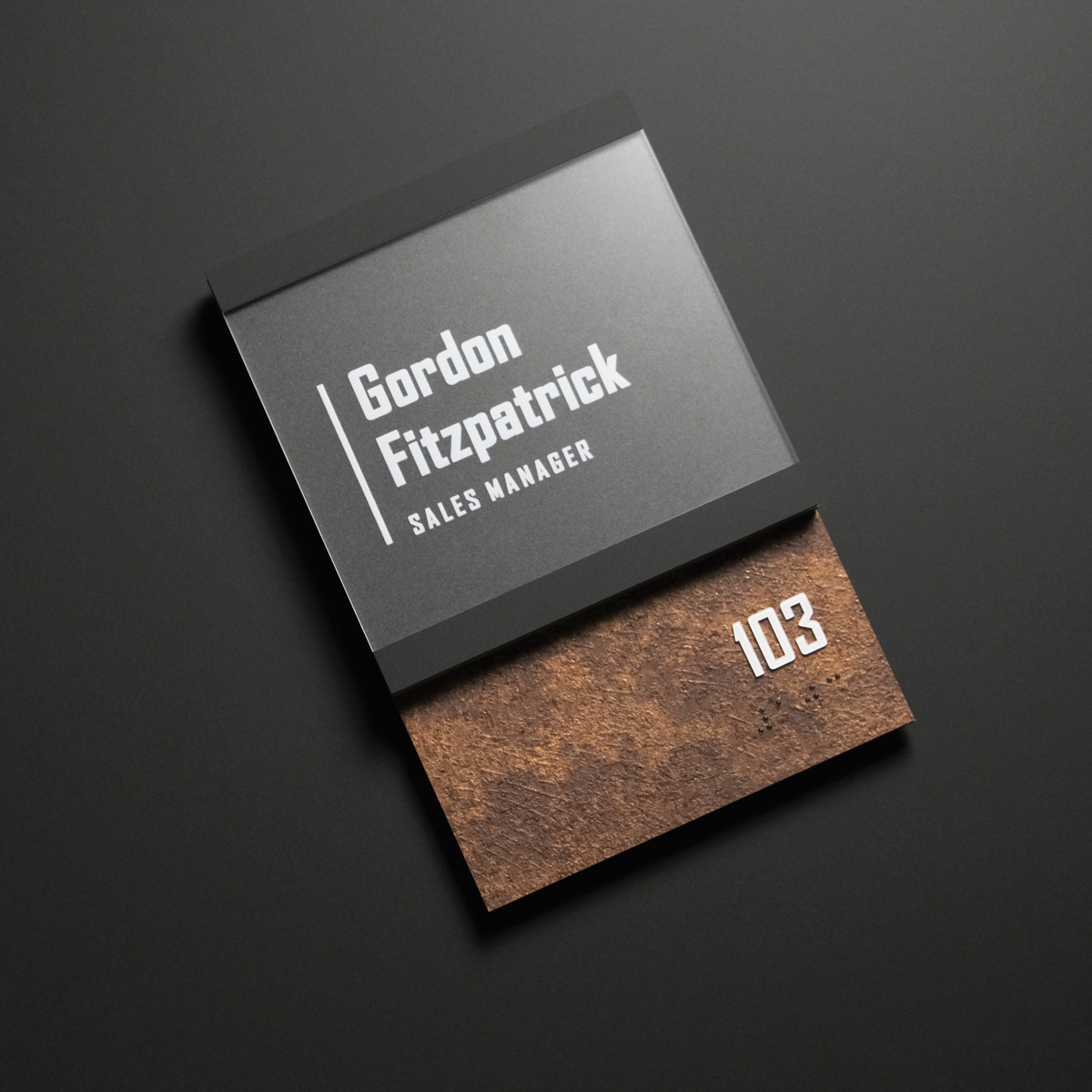 A contemporary interior sign with matte black and rusted metal finished and an updateable clear insert